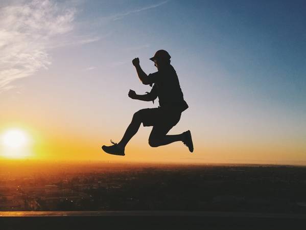 Silhouette of a man jumping.