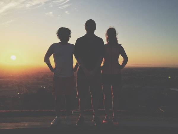 Three people's silhouettes.