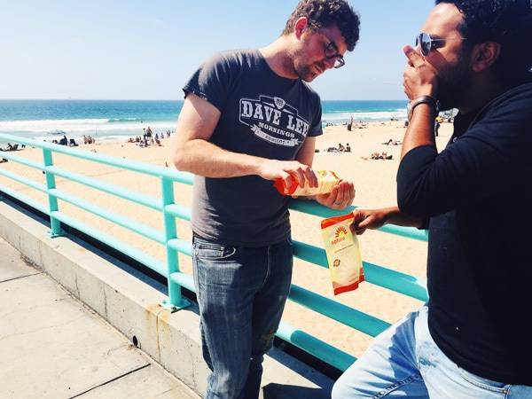 Men eating snacks.