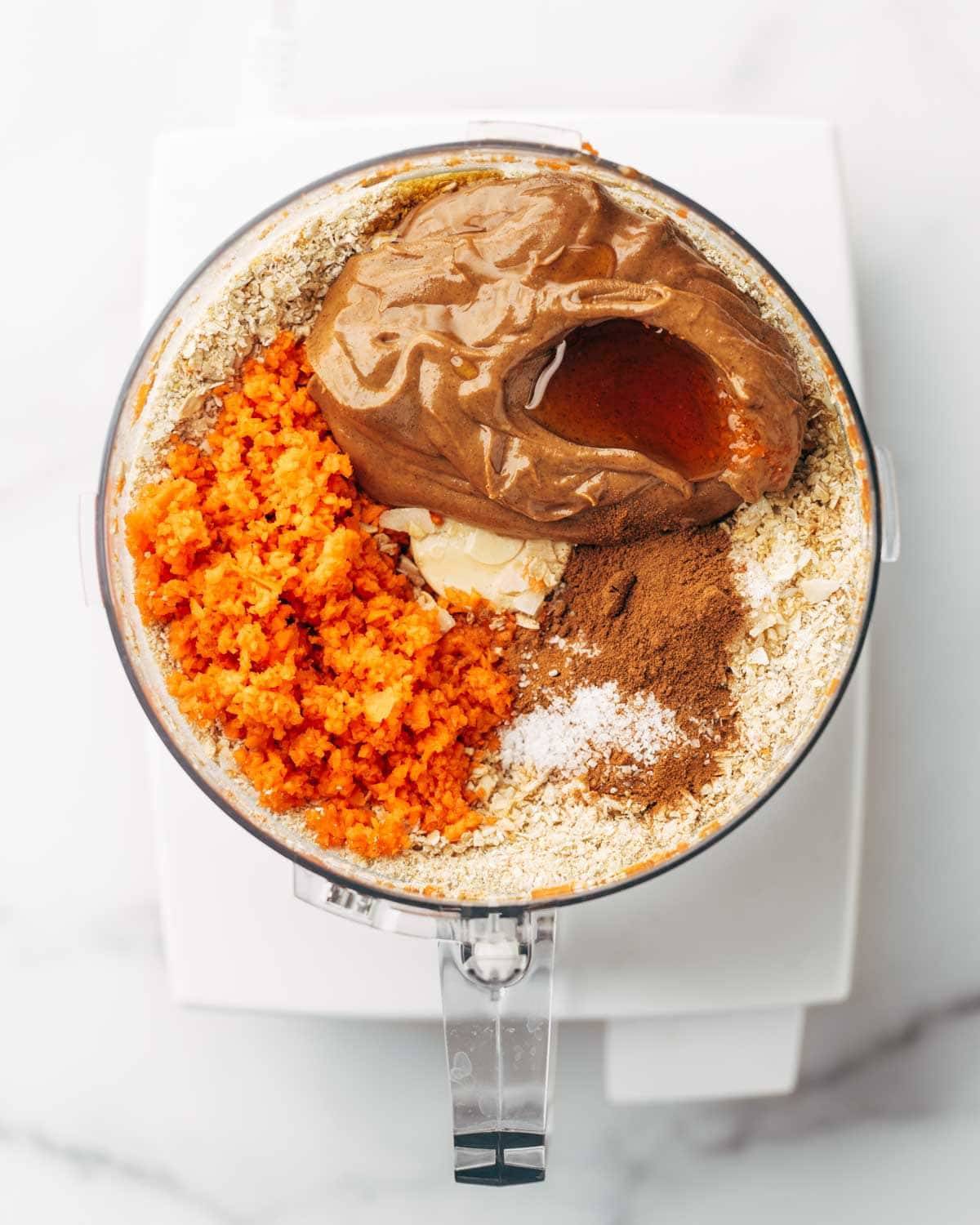 Ingredients for carrot cake bites in a food processor before blending.