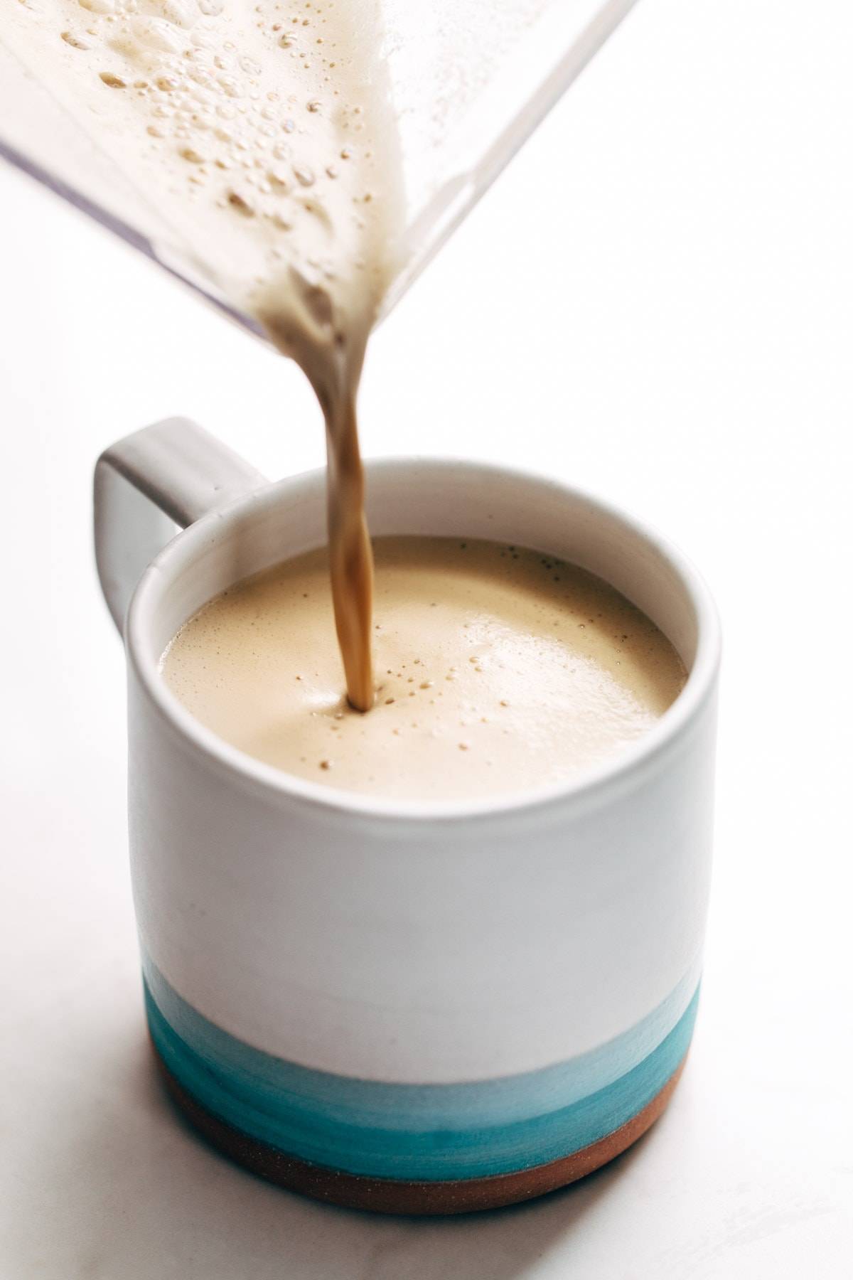 Cashew coffee poured into mug.