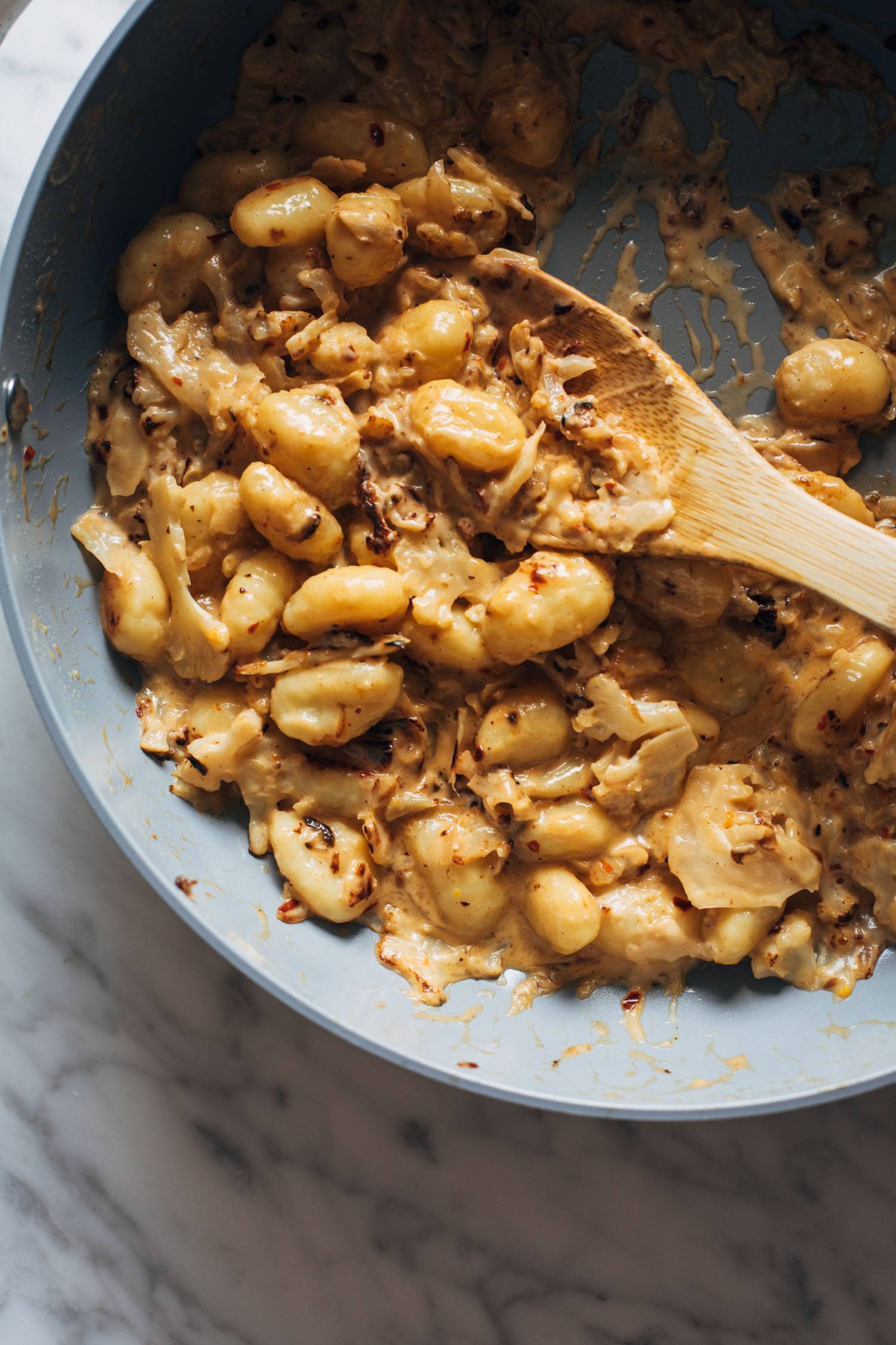 Cauliflower orange gnocchi in a pan.