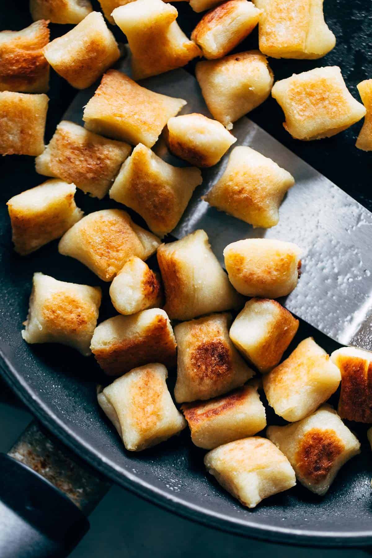 Cauliflower gnocchi crisped in a pan.