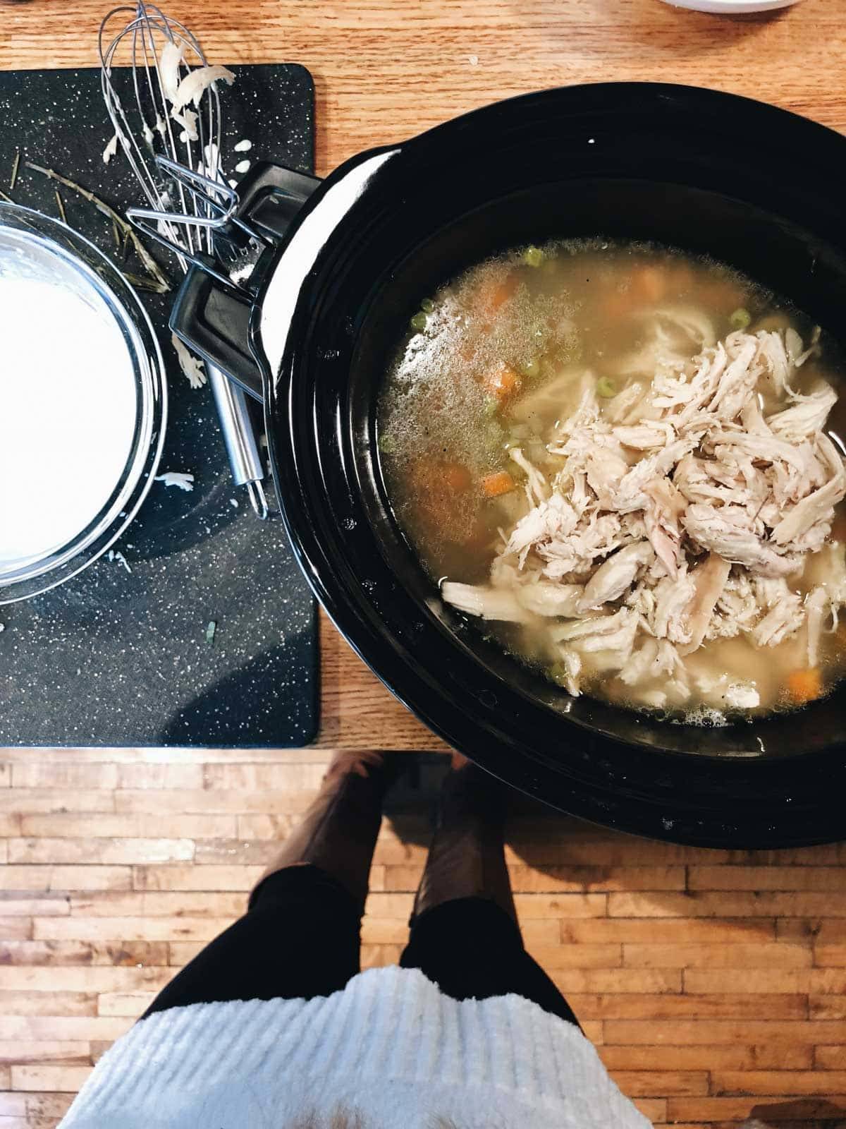 Slow Cooker Chicken Pot Pie Soup in slow cooker with chicken shredded.