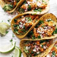 Chicken Tinga Tacos in a row.