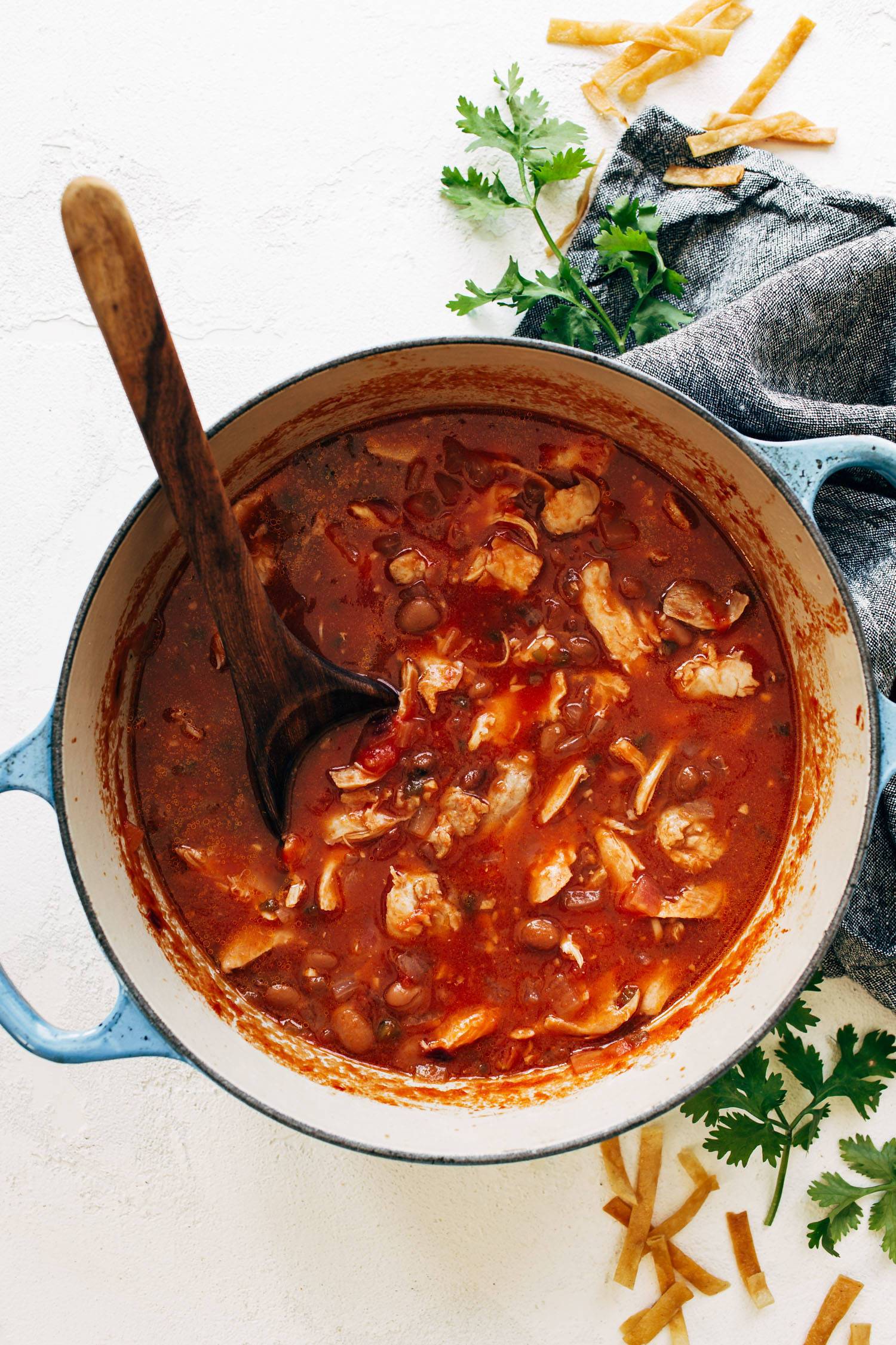 Chicken Tortilla Soup in a soup pot with a ladle.