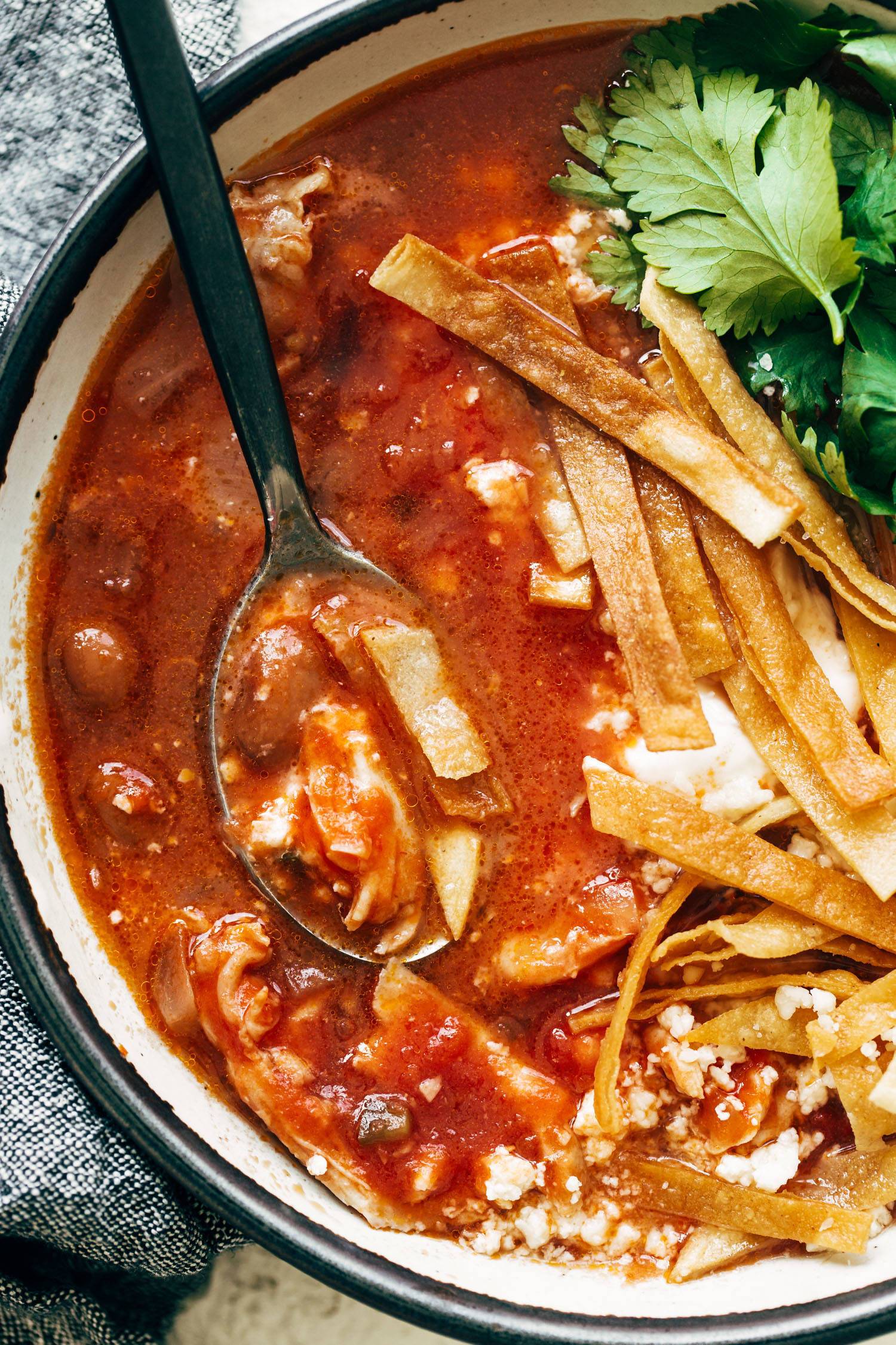 Chicken Tortilla Soup in a bowl with a spoon.