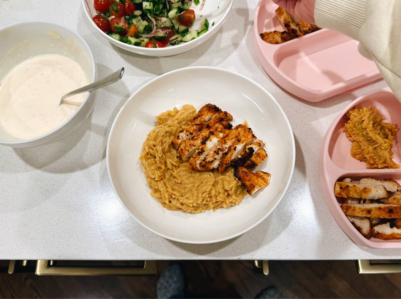 Sliced chicken and banza rice in a bowl.