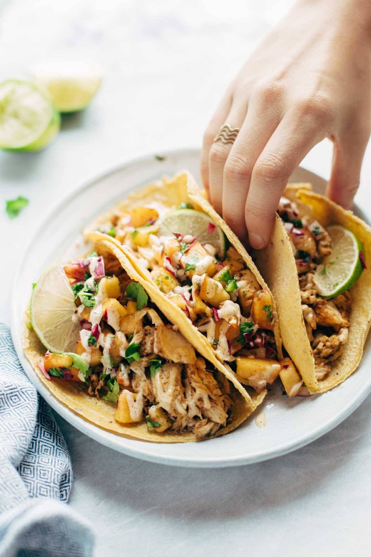 Hand grabbing a Chili Lime Fish Taco.