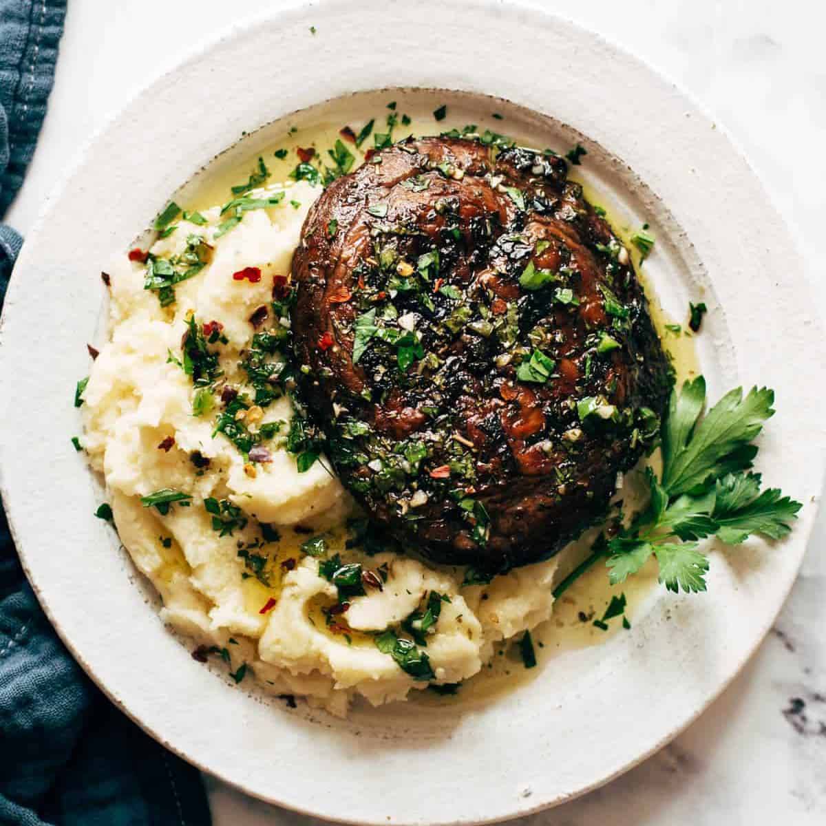 Portobello mushroom on a bed of mashed potato.