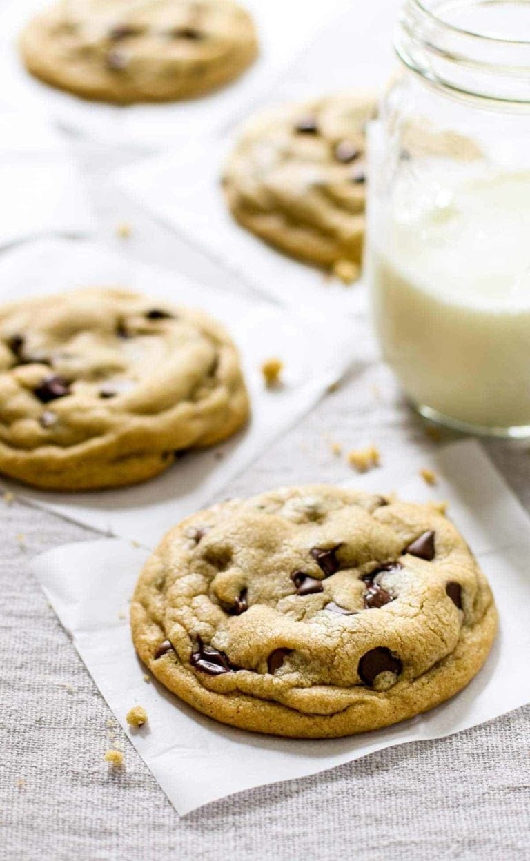 Soft chocolate chip cookies with a glass of milk.