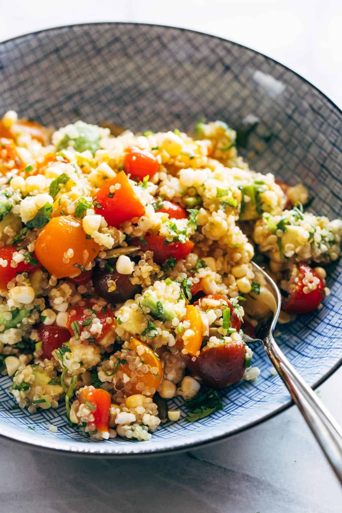 Corn, Avocado, and Quinoa Salad in a bowl with a fork.