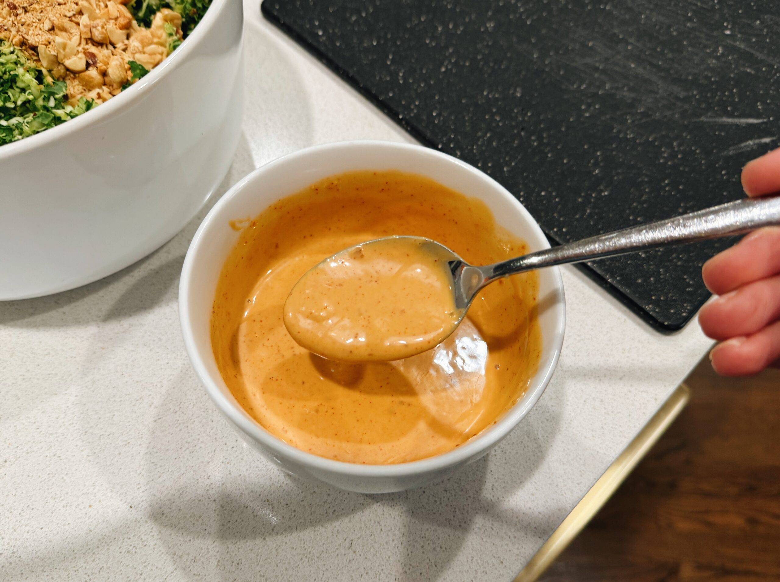 Spoonful of gochujang sauce in a bowl.