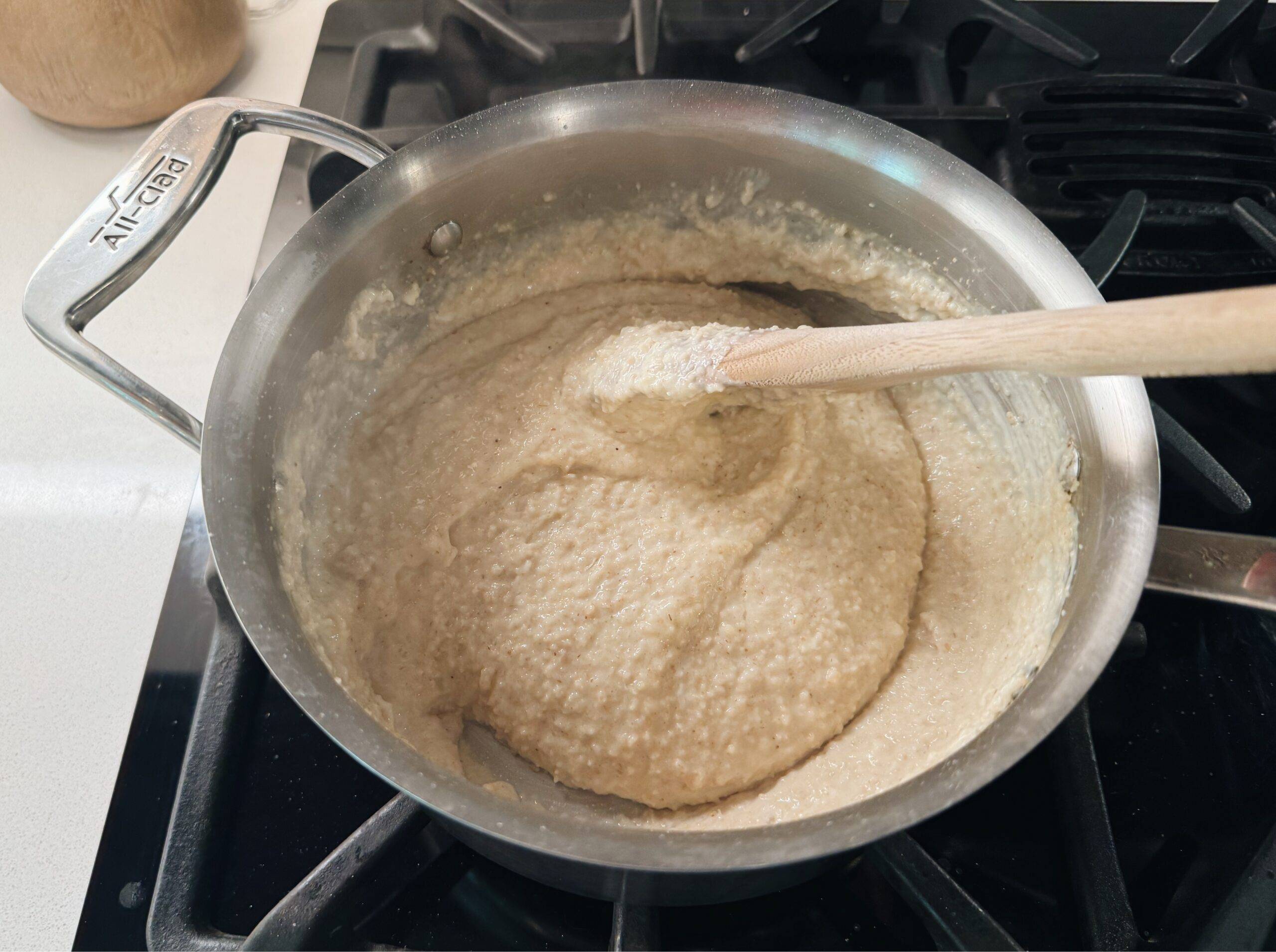 Mixing the egg into the oat bran in the pot.