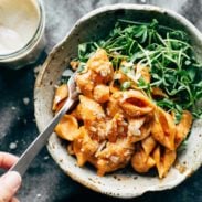 Creamy Tomato Shells in bowl with greens.