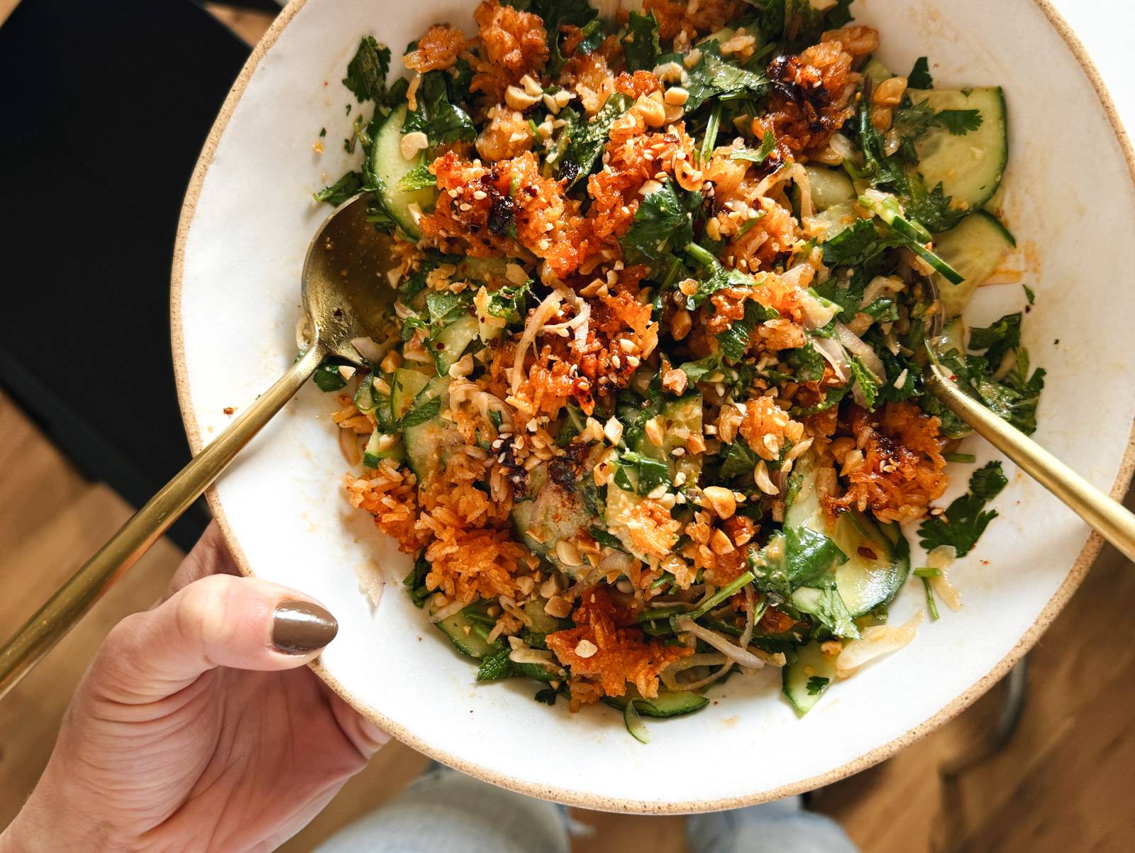 Mixed salad in a bowl with spoons.