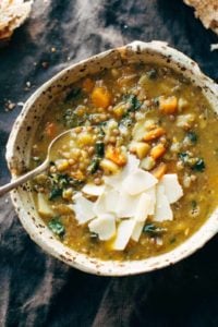 Detox Crockpot Lentil Soup in bowl with a spoon.