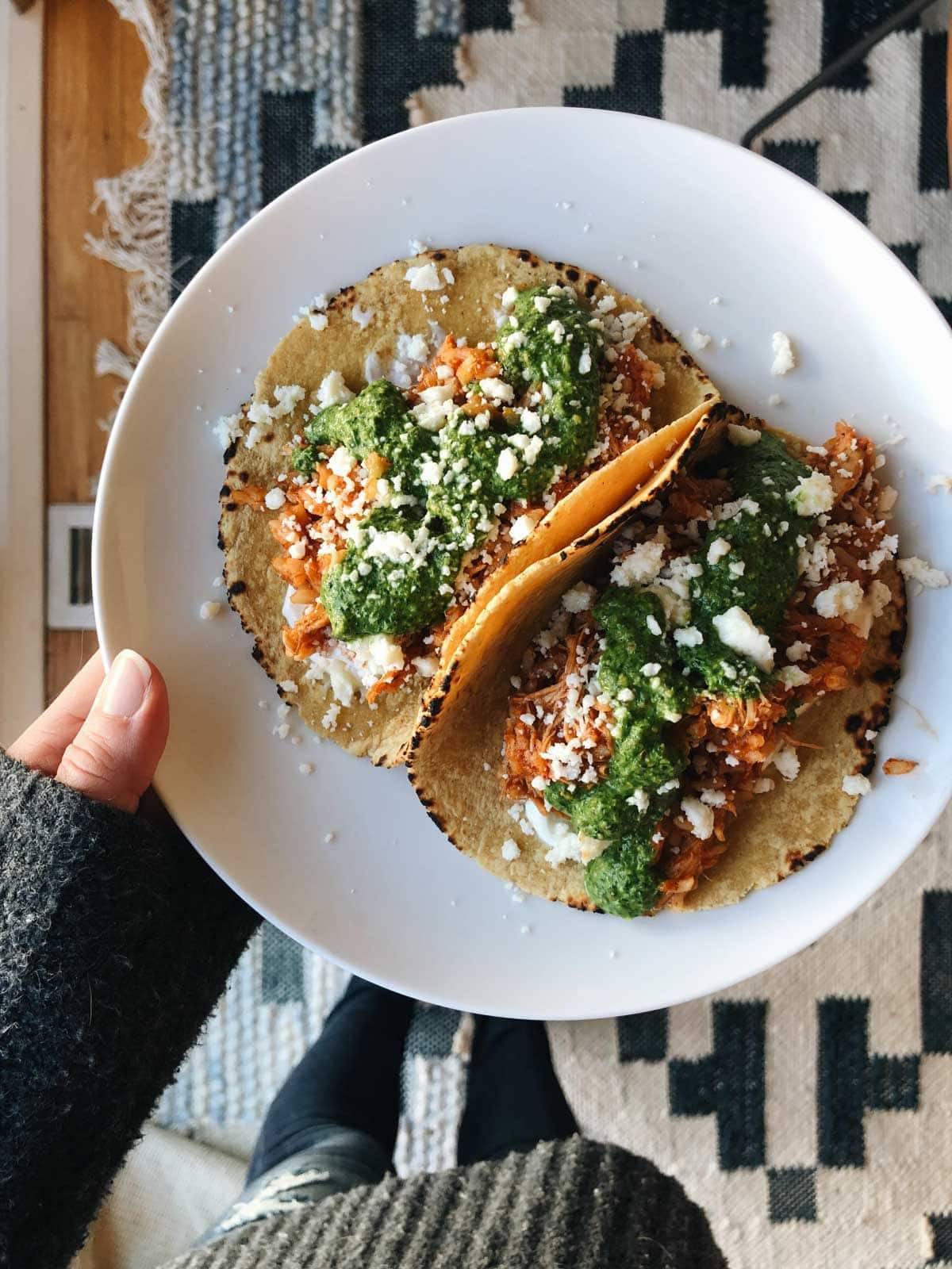 Chicken tinga tacos on a plate.