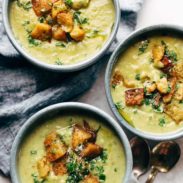 Detox Broccoli Cheese Soup on bowls with cloth napkin.