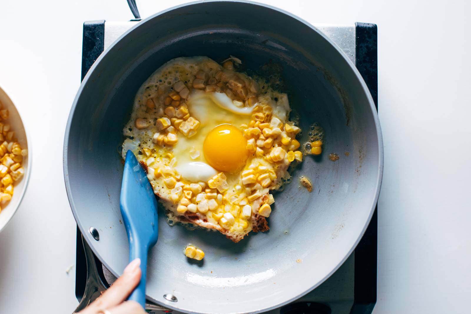 Folding the edges in to contain the egg.