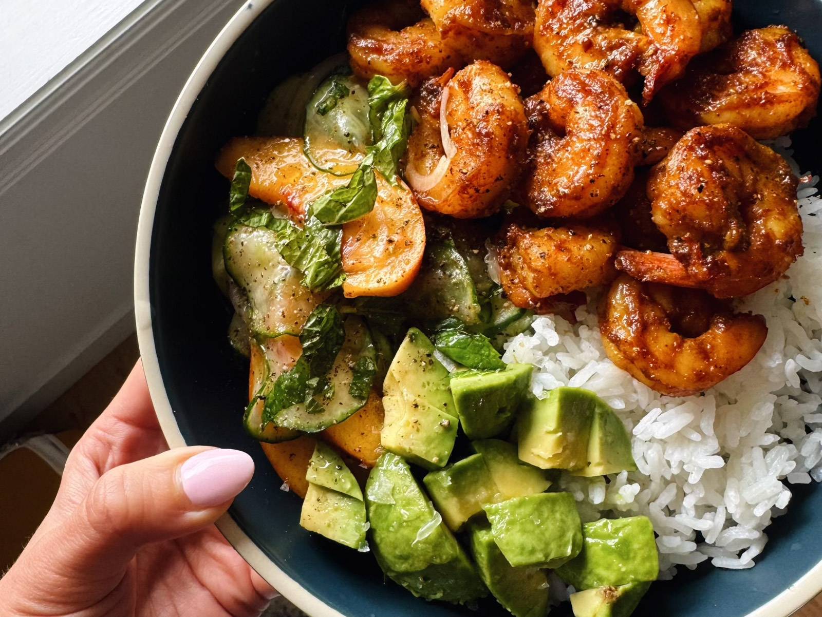 Bowl with shrimp, rice, and shrimp salad.