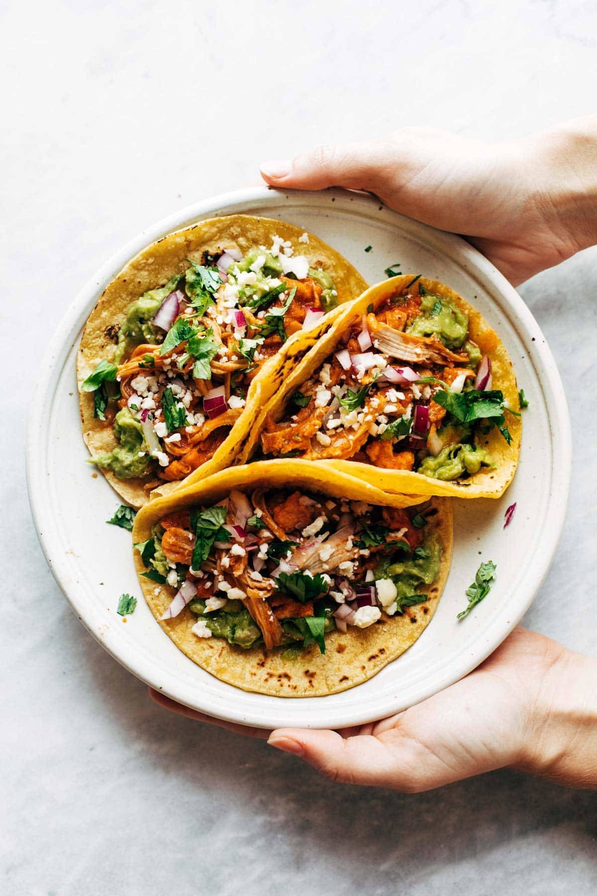 Chicken Tinga tacos on a plate.