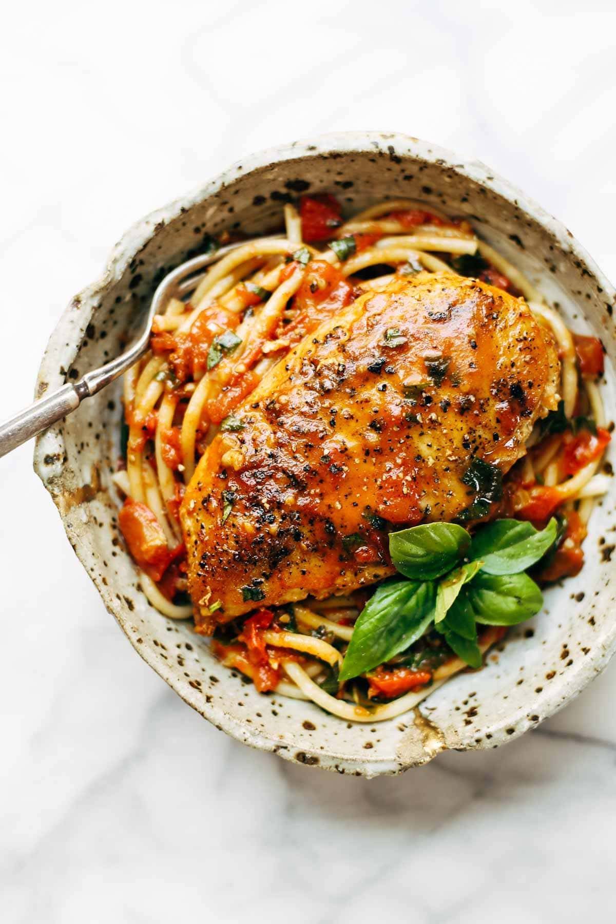 Garlic Basil Chicken - you won't believe that this easy real food recipe only requires 7 ingredients like basil, garlic, olive oil, tomatoes, and butter. | pinchofyum.com