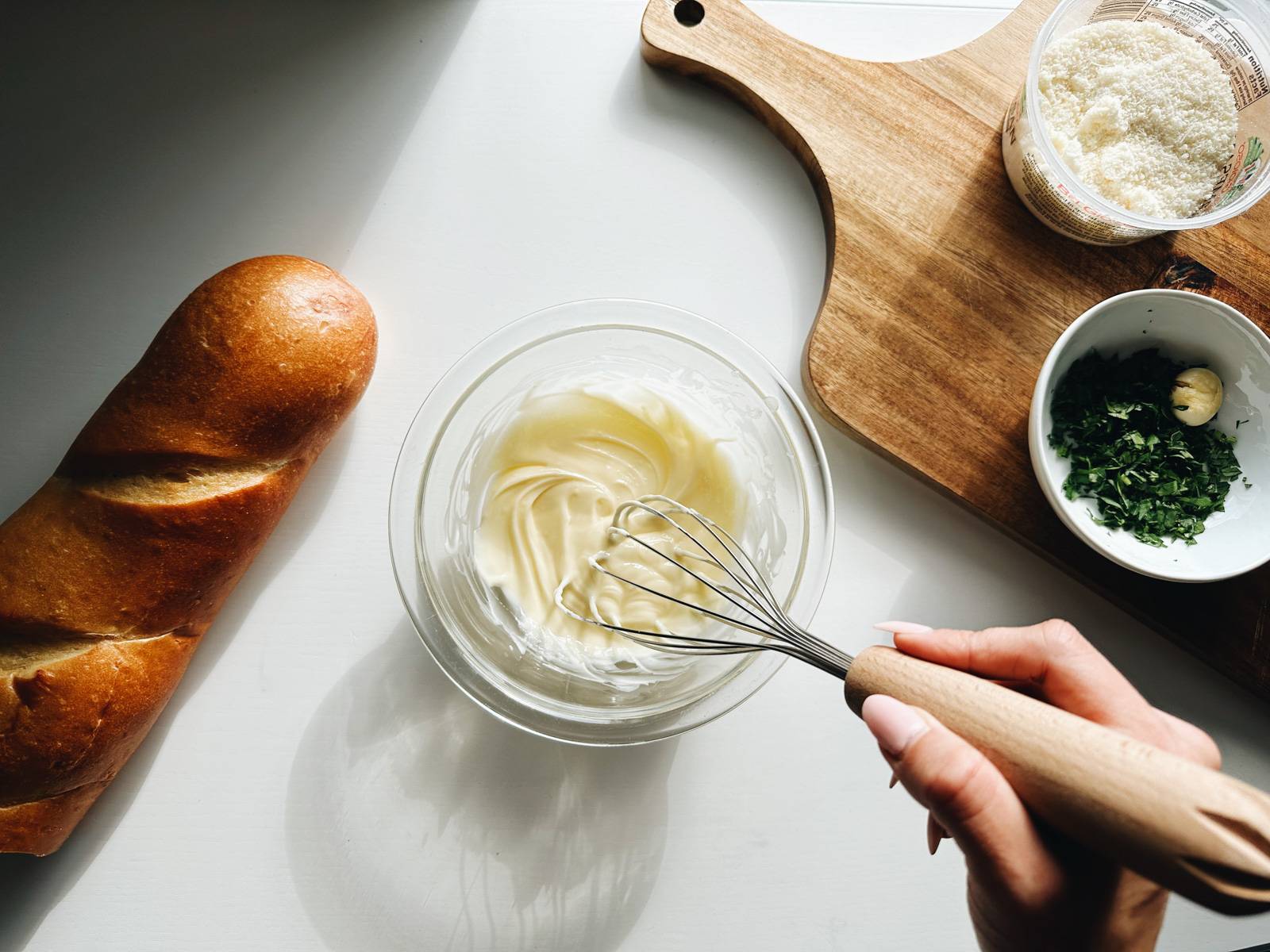 Whisking butter in a bowl to spread on bread.