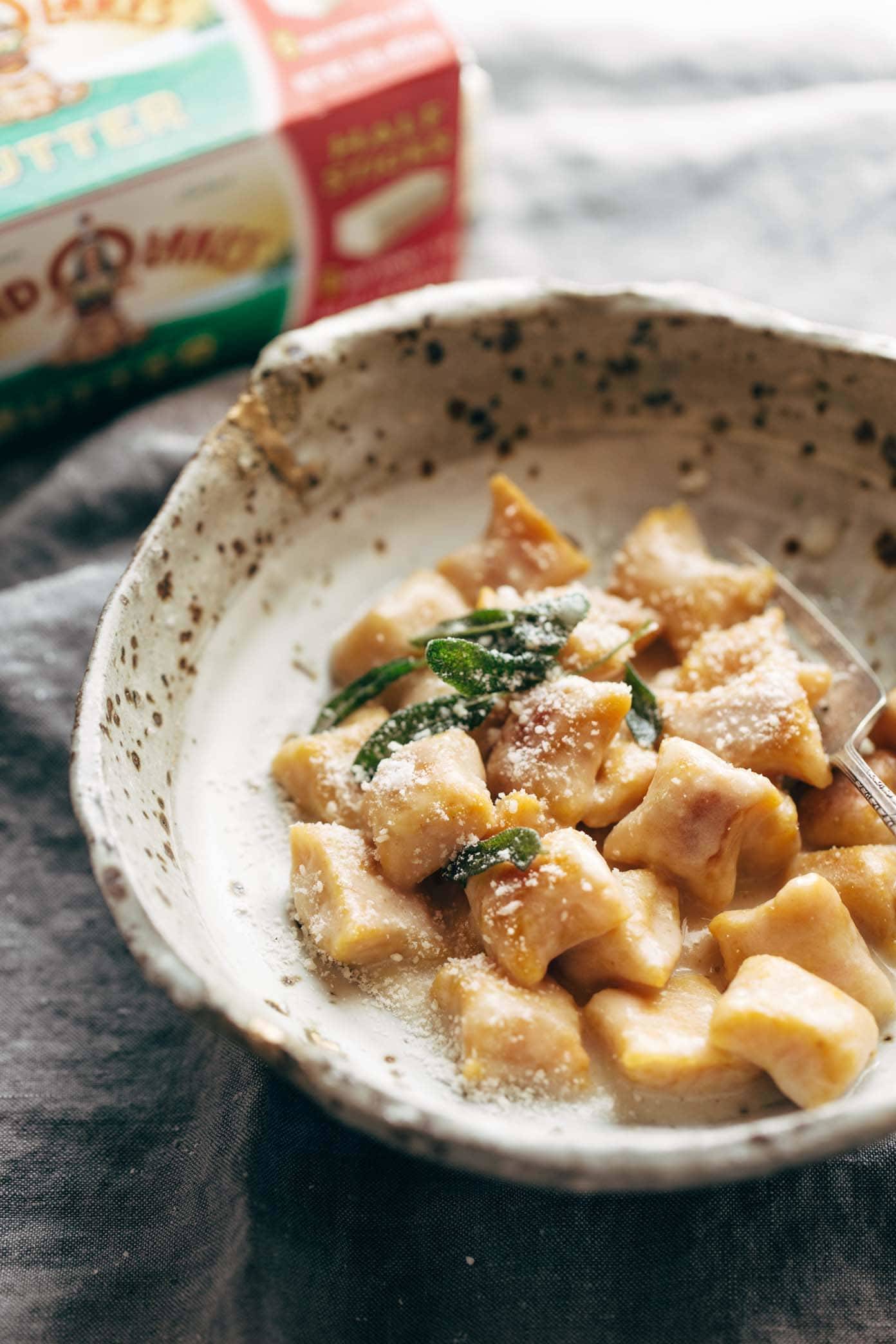 Pumpkin Gnocchi! So incredibly pillowy and delicious. Topped with a 5 ingredient sage garlic butter sauce that will blow your mind. | pinchofyum.com