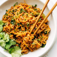 Gochujang noodles in a bowl with chopsticks.