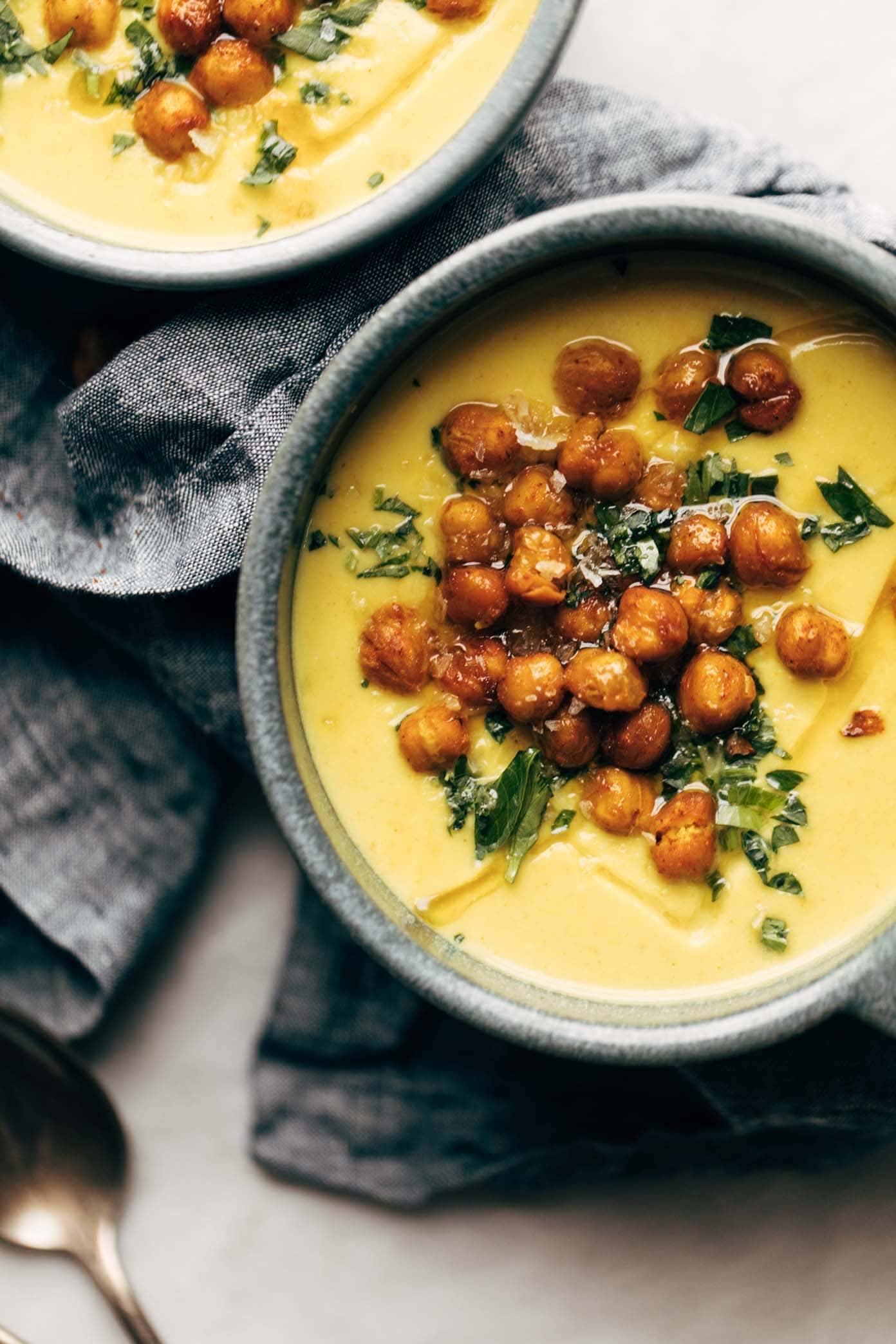 Two bowls of Golden Soup on a dark napkin.