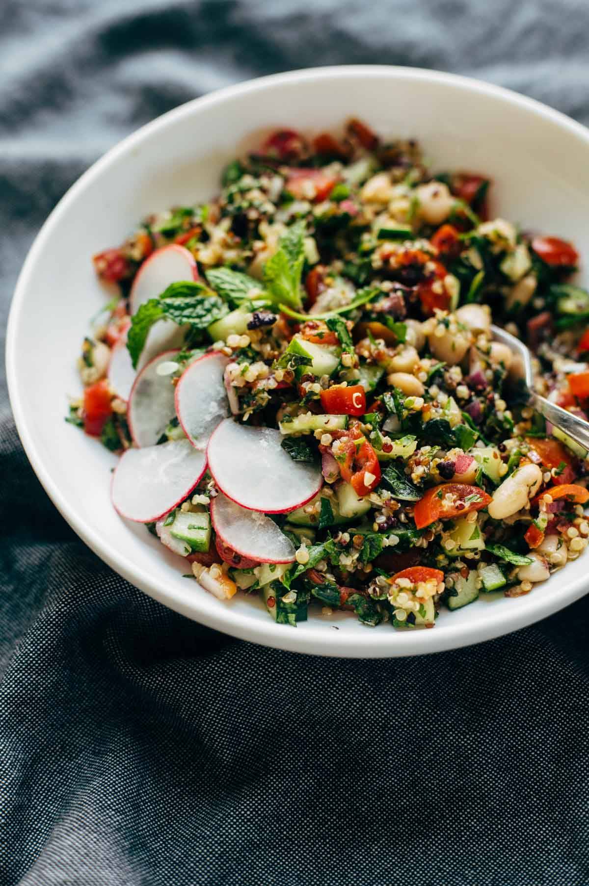 Greek salad in a bowl with a fork.