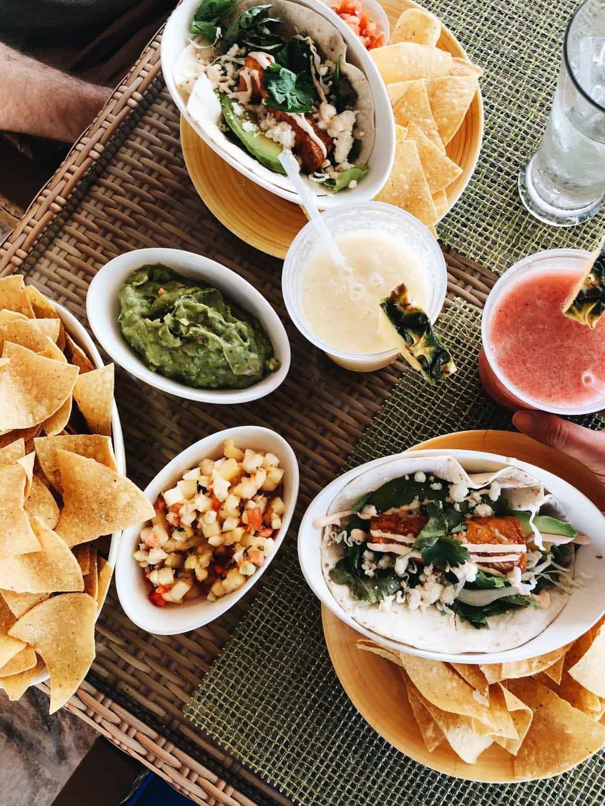 Table with plates and bowls of food.