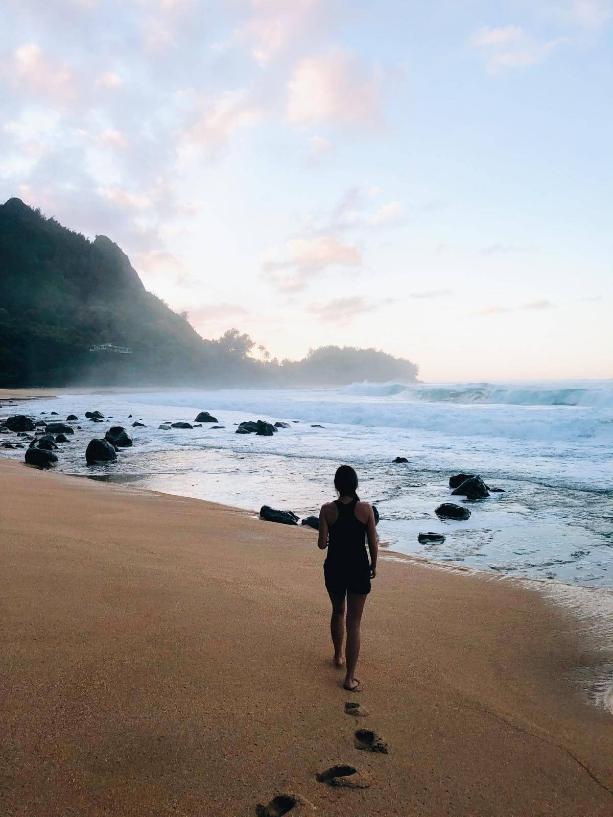 Woman walking on a beach.