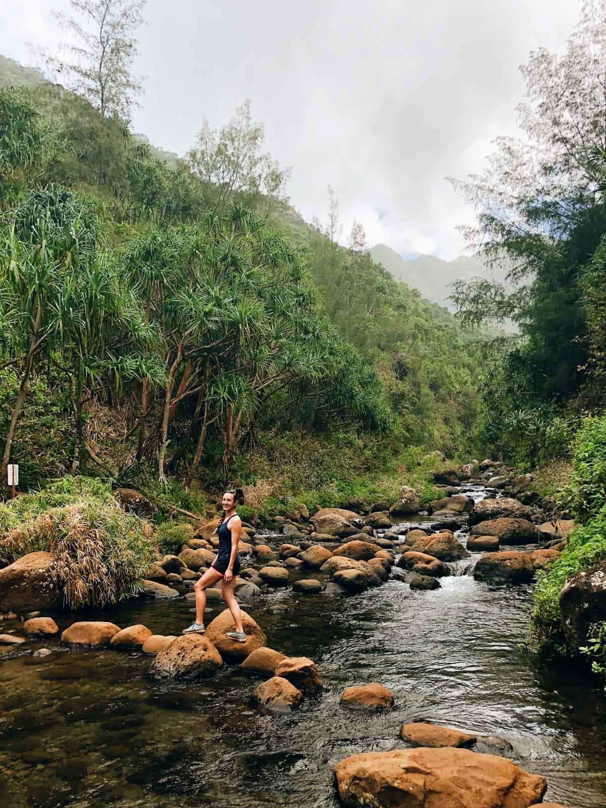 Woman walking on rocks.