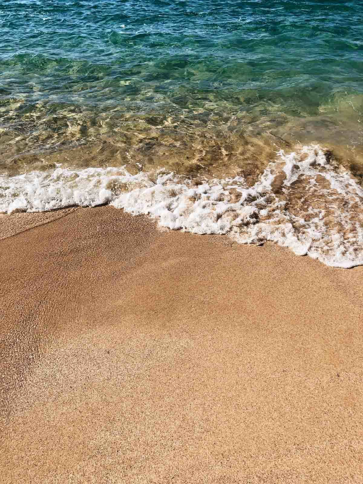 Ocean waves hitting the beach sand.