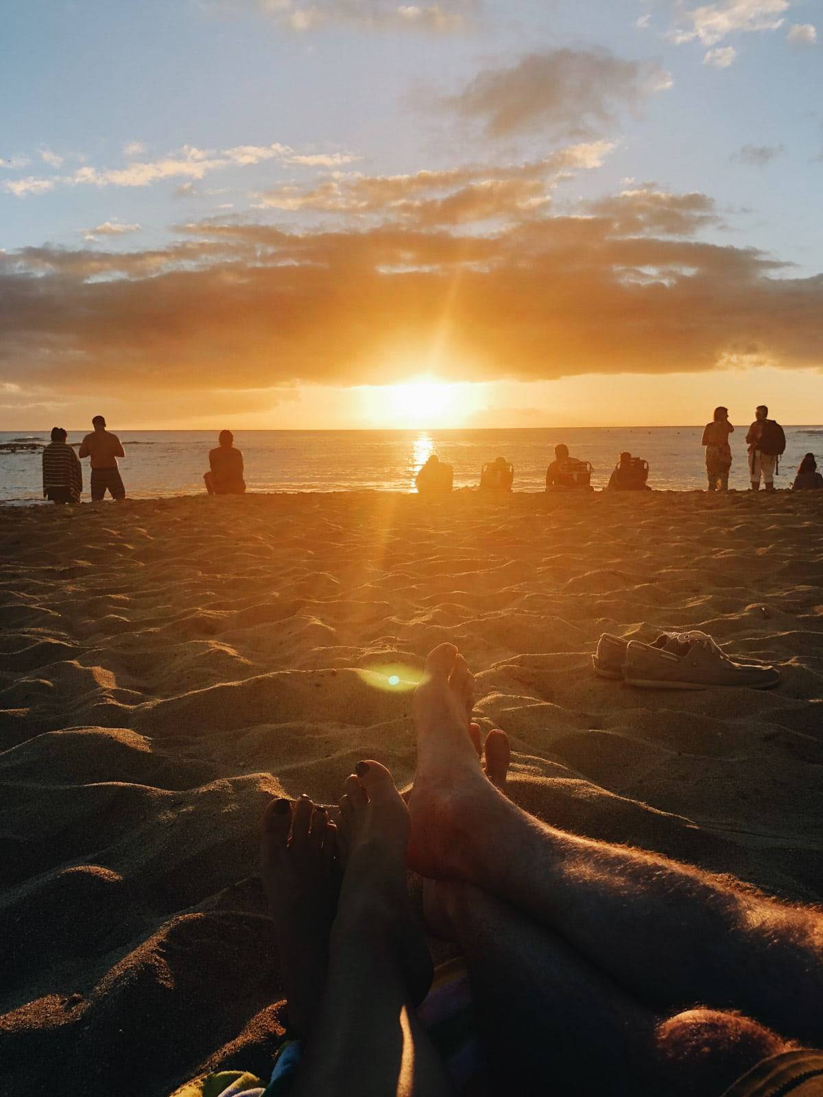 People on the beach during sunset.