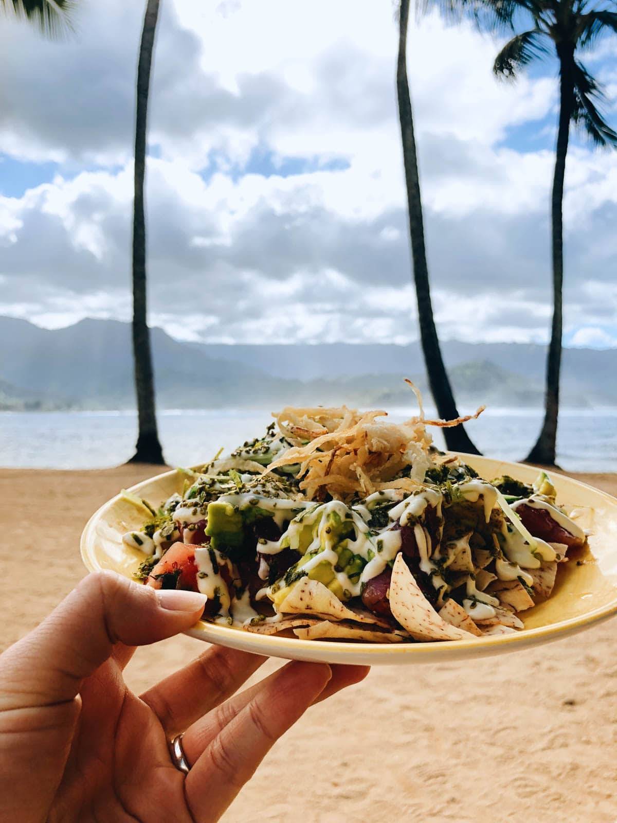 Food on a plate on the beach.