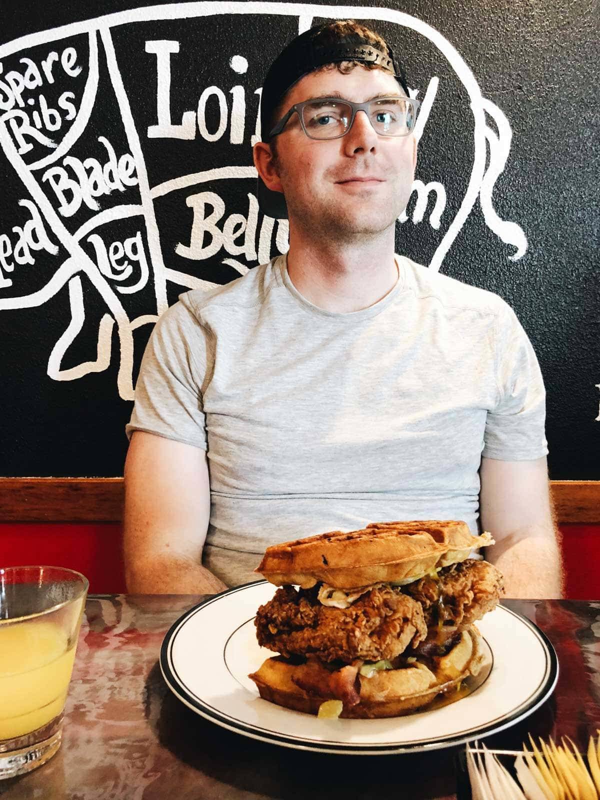 Man sitting at a table with a plate of food.