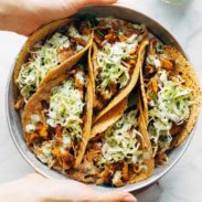 Instant Pot Hawaiian Chicken Tacos with Jalapeño Ranch Slaw stacked next to each other in a bowl.