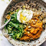 Bowl with rice, sweet potatoes, greens, and a poached egg.