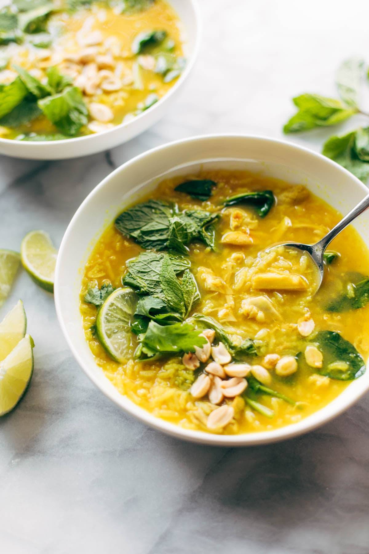 Chicken and rice soup in a bowl with spoon.