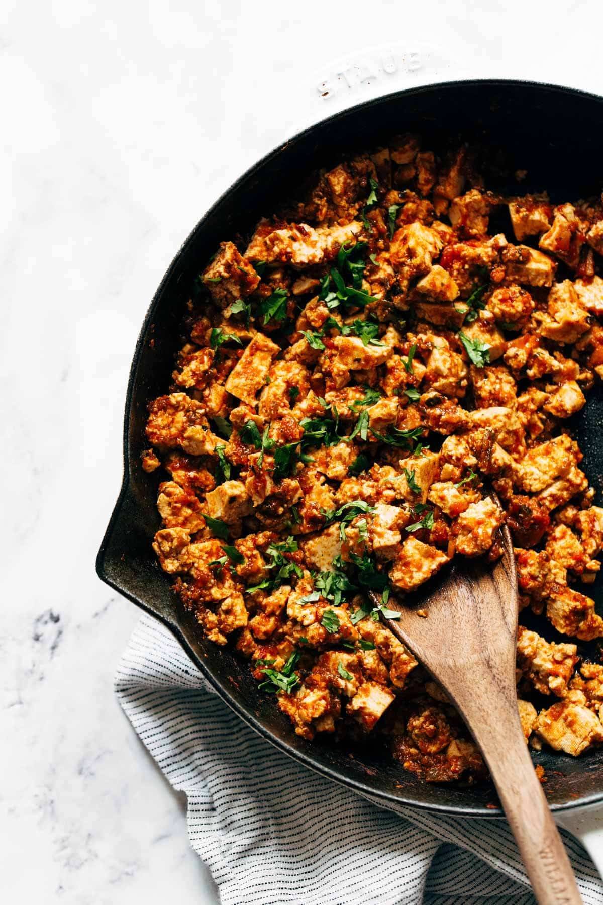 Sofritas in a skillet with a wooden spoon