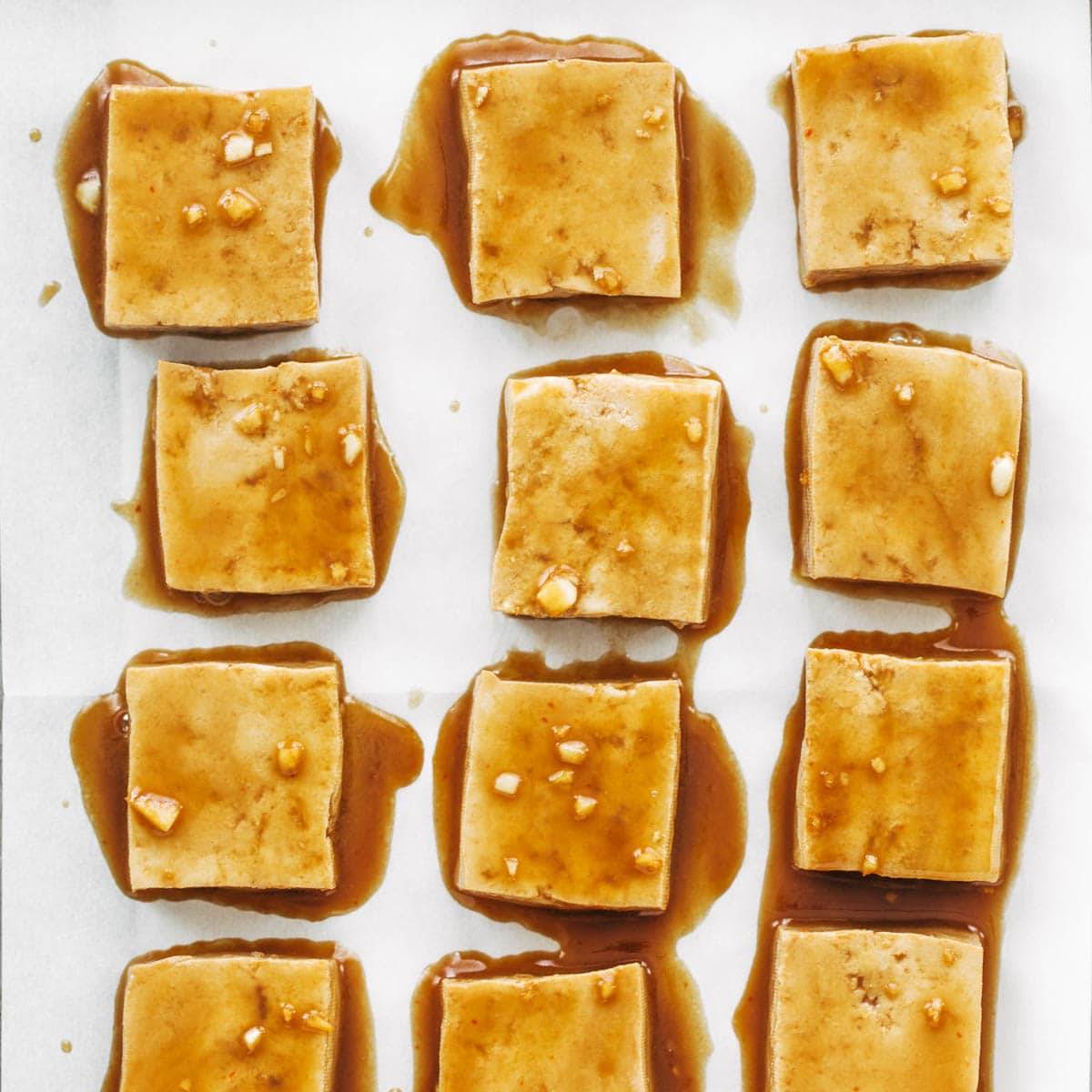 Marinated tofu on baking sheet.