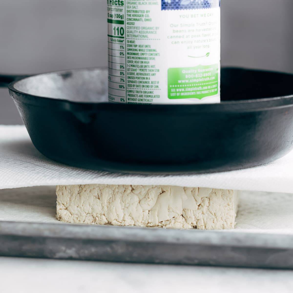 Pressing water out of tofu.