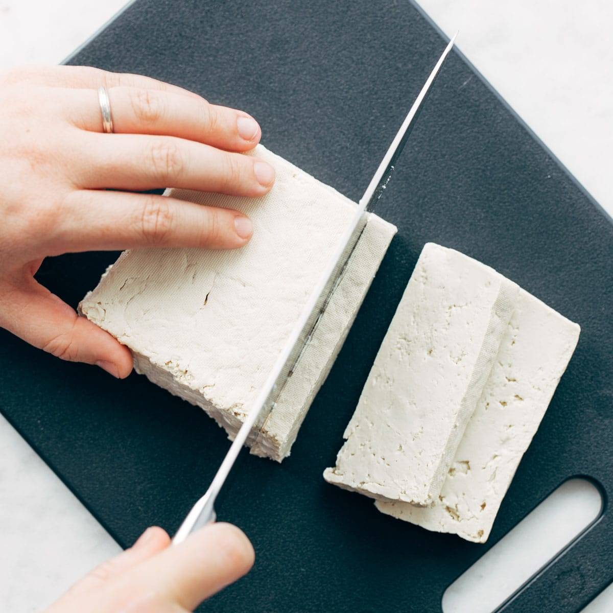 Slicing tofu into blocks.