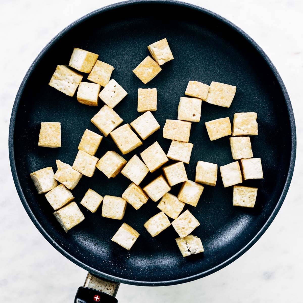 Tofu in a sautè pan.