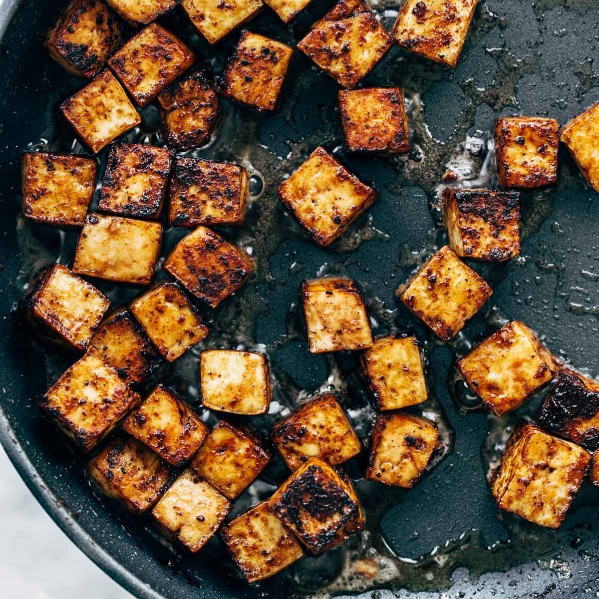 Sautèed tofu in a pan.