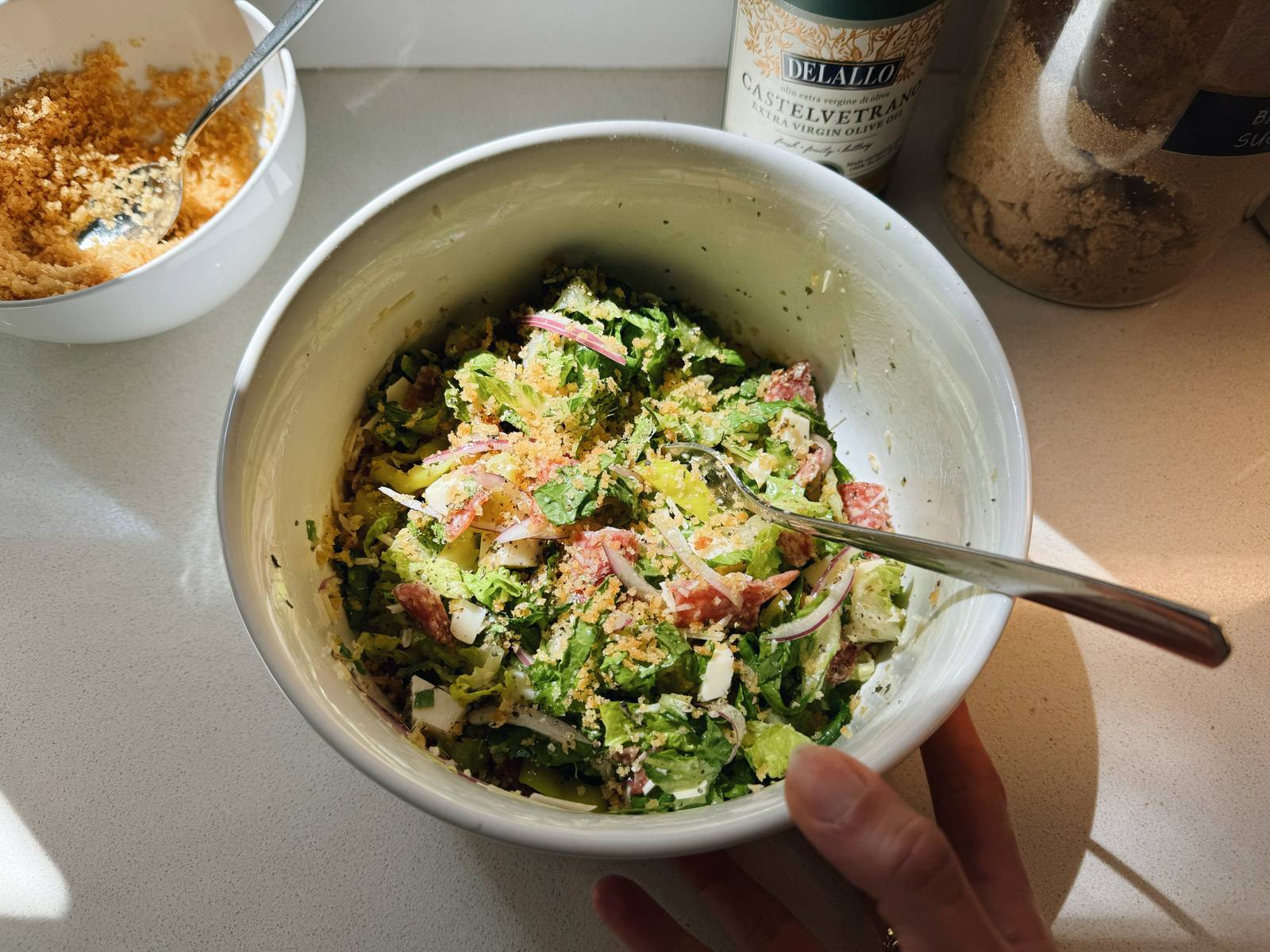 Tossed Italian salad in a bowl with a fork.