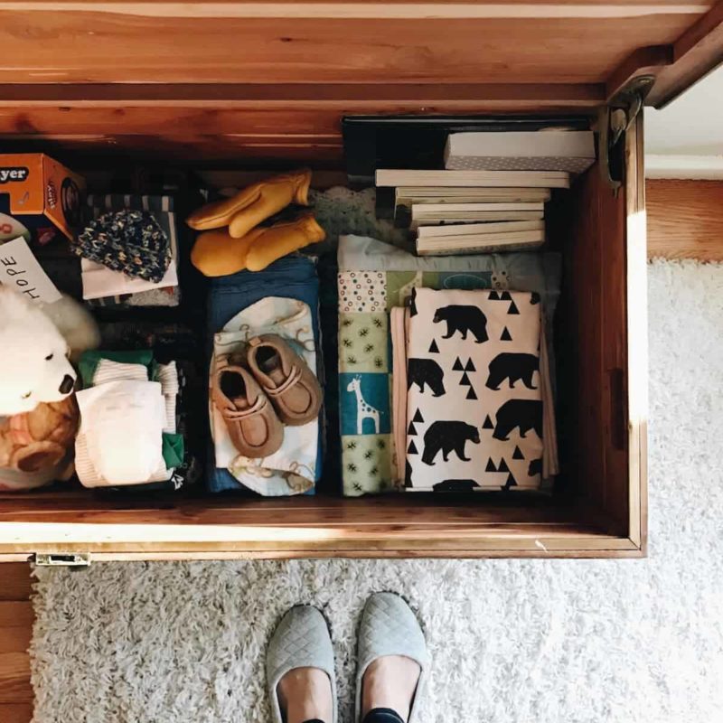 A chest containing books, boots, gloves and other apparel.